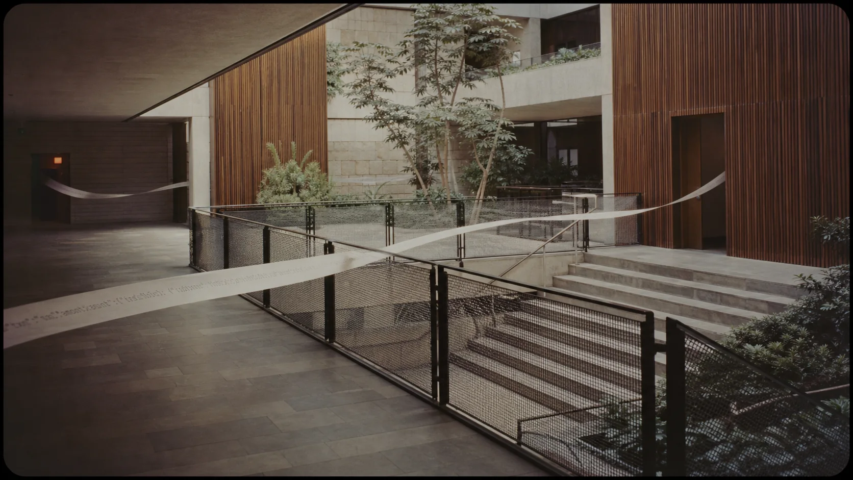 Structured commercial traces crossing an open institutional space toward separate entrances.